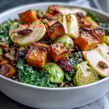 A vibrant Fall Vegetable Bowl with caramelized apples, hearty farro, and autumn spices on a cozy dinner plate.  