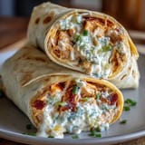 Spicy Buffalo chicken cream cheese spread rolled in soft tortillas and sliced into party-ready pinwheels.  