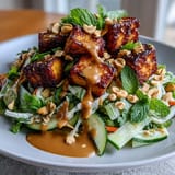 Juicy mango salad topped with golden tofu, drizzled in peanut sauce.