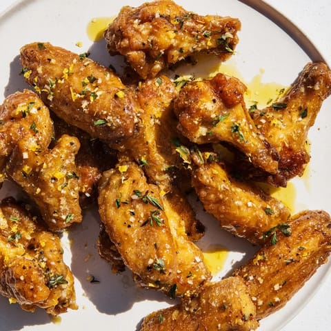 A close-up of generously coated Lemon Pepper Wings revealing the flavorful blend of seasonings.