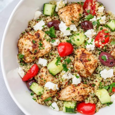 Hearty Mediterranean Chicken Bowl featuring golden chicken, creamy feta, Kalamata olives, chickpeas, and vibrant veggies drizzled with zesty lemon-oregano dressing.