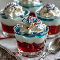 Vibrant 4th of July Firecracker Jello Shots with three layered patriotic colors.